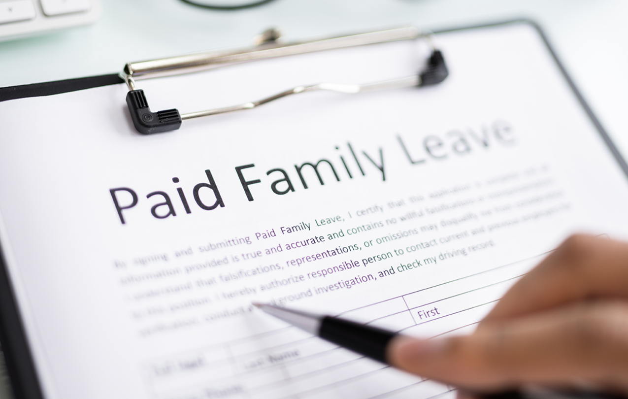 Filling out a Paid Family Leave Document. Photo Credit: Andrey Popov/ Getty Image
